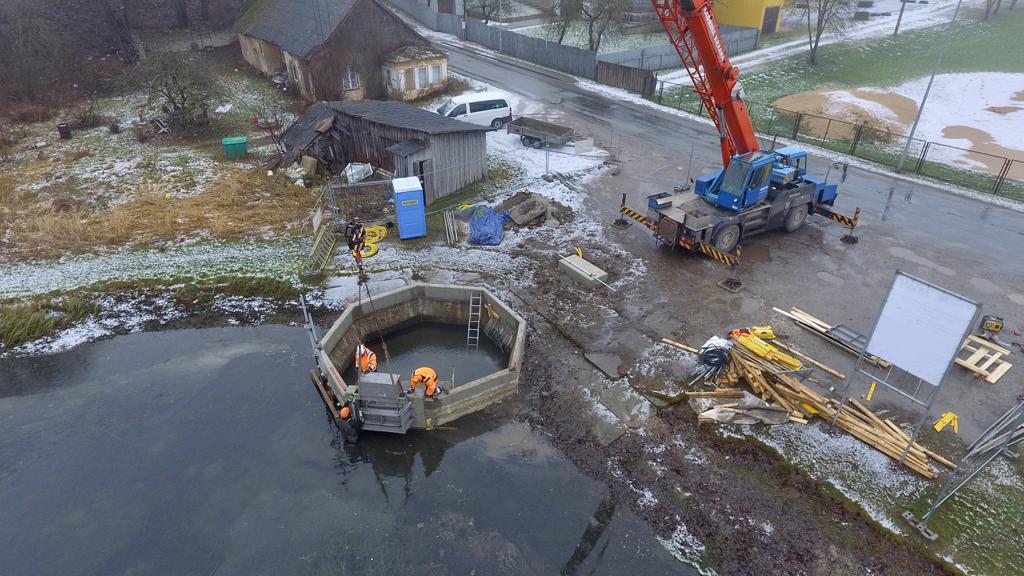 Varja montaaž – betoonrõnga paigaldus kraanaga, töötajad kaevus